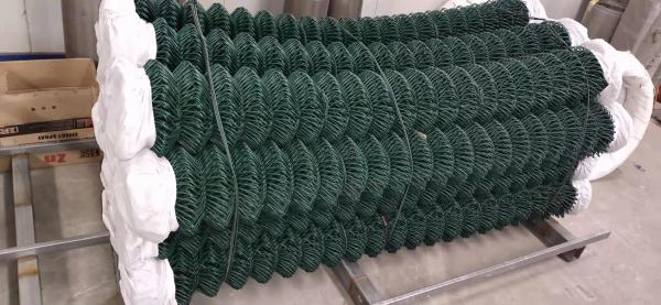 A bundle of dark green PVC coated chain link wire.